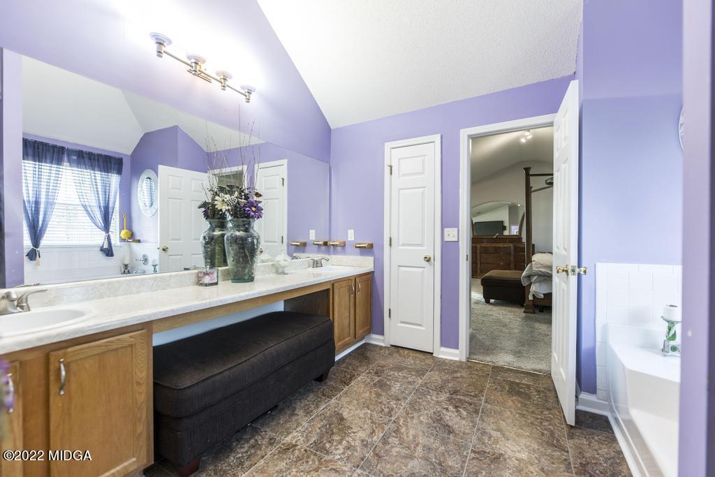 825 Kohl Drive McDonough, GA 30253 - Photo 41 of 59 a en suite bathroom with a sink double vanity and a mirror