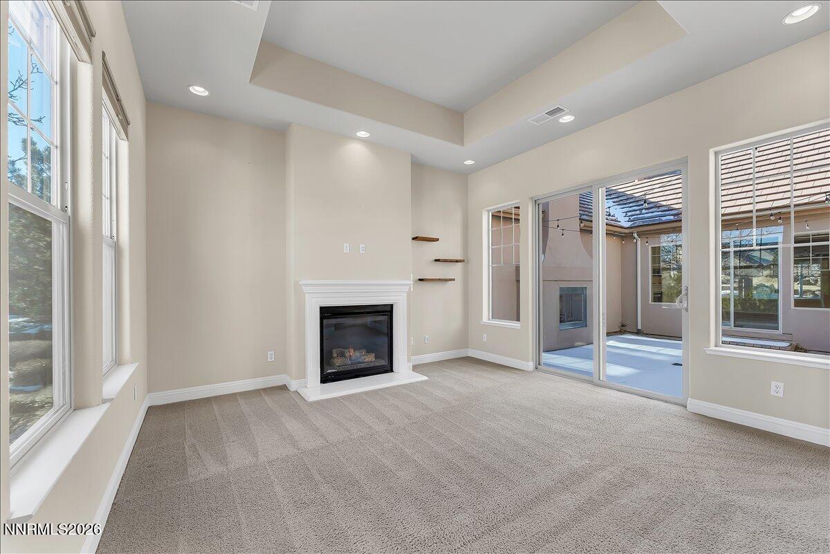 16920 Delacroix Reno, NV 89511 - Photo 11 of 25 a view of an empty room with a fireplace and a window