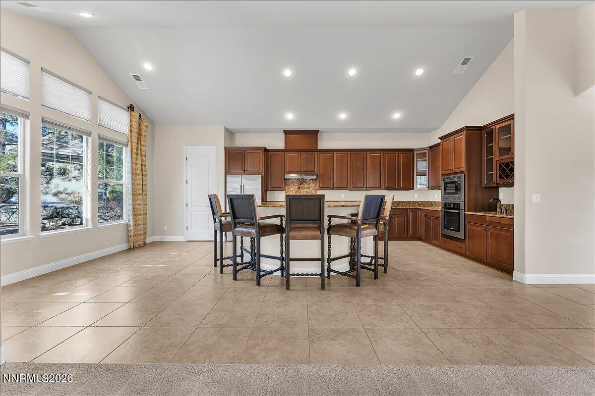 16920 Delacroix Reno, NV 89511 - Photo 12 of 25 a view of kitchen with kitchen island dining table and stainless steel appliances