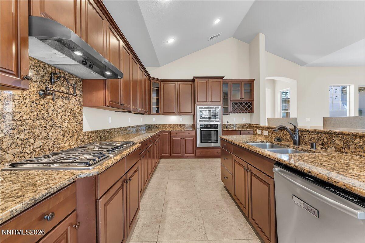 16920 Delacroix Reno, NV 89511 - Photo 13 of 25 a large kitchen with stainless steel appliances granite countertop a stove sink and cabinets