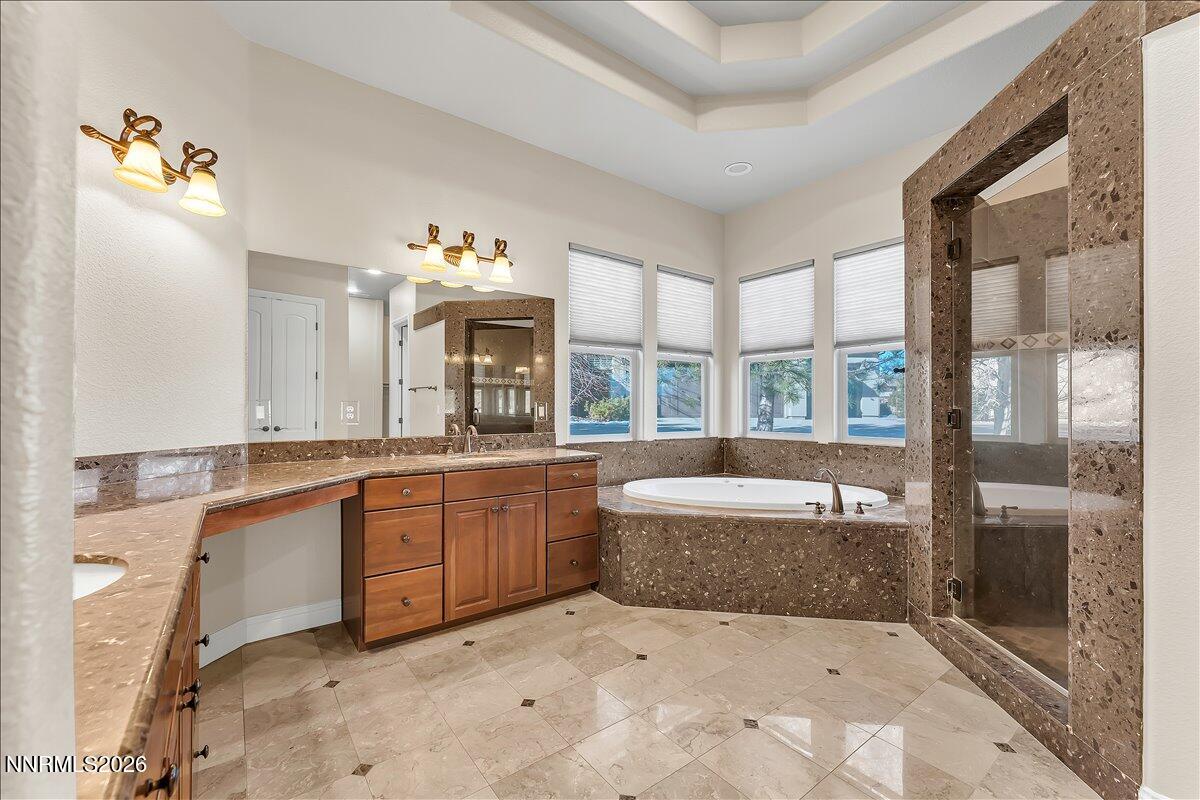 16920 Delacroix Reno, NV 89511 - Photo 19 of 25 a large spacious bathroom with a tub sink and mirror