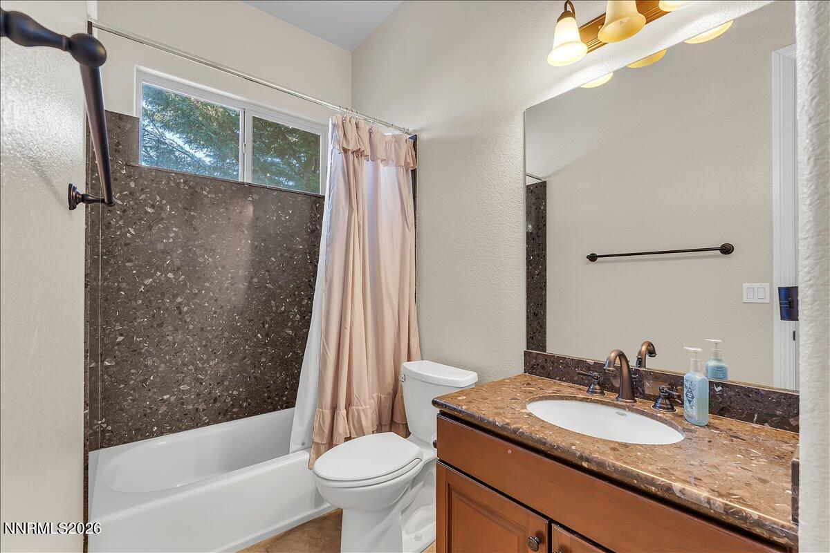 16920 Delacroix Reno, NV 89511 - Photo 22 of 25 a bathroom with a granite countertop sink toilet and shower