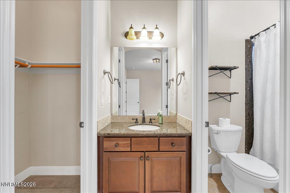 16920 Delacroix Reno, NV 89511 - Photo 24 of 25 a bathroom with a granite countertop sink toilet and shower