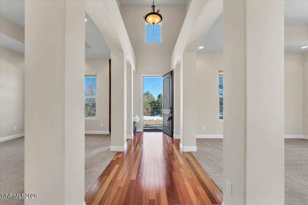 16920 Delacroix Reno, NV 89511 - Photo 7 of 25 a view of a hallway with wooden floor and staircase