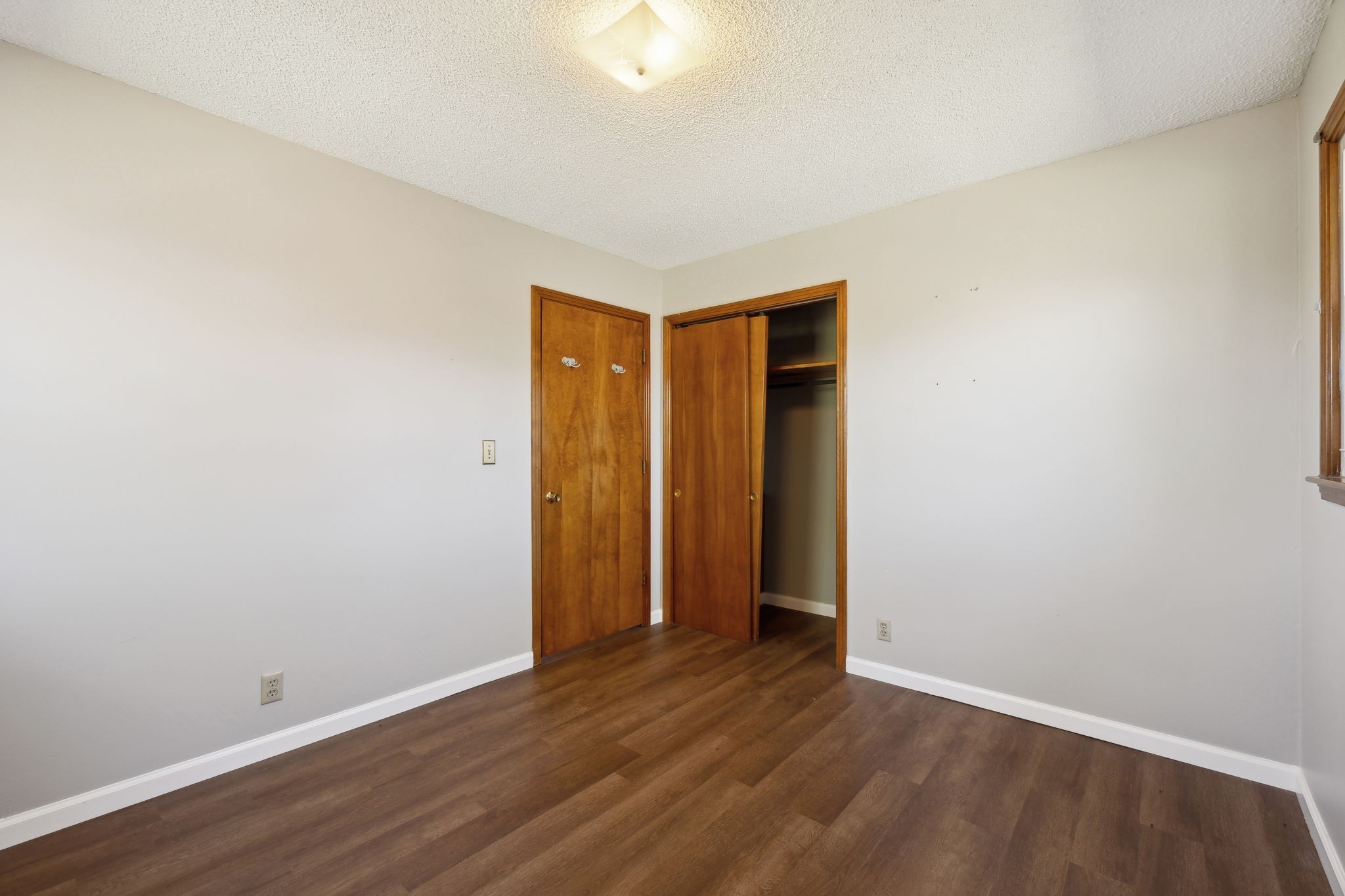 5880 Carthage Road Pleasant Shade, TN 37145 - Photo 23 of 45 a view of an empty room with wooden floor and closet