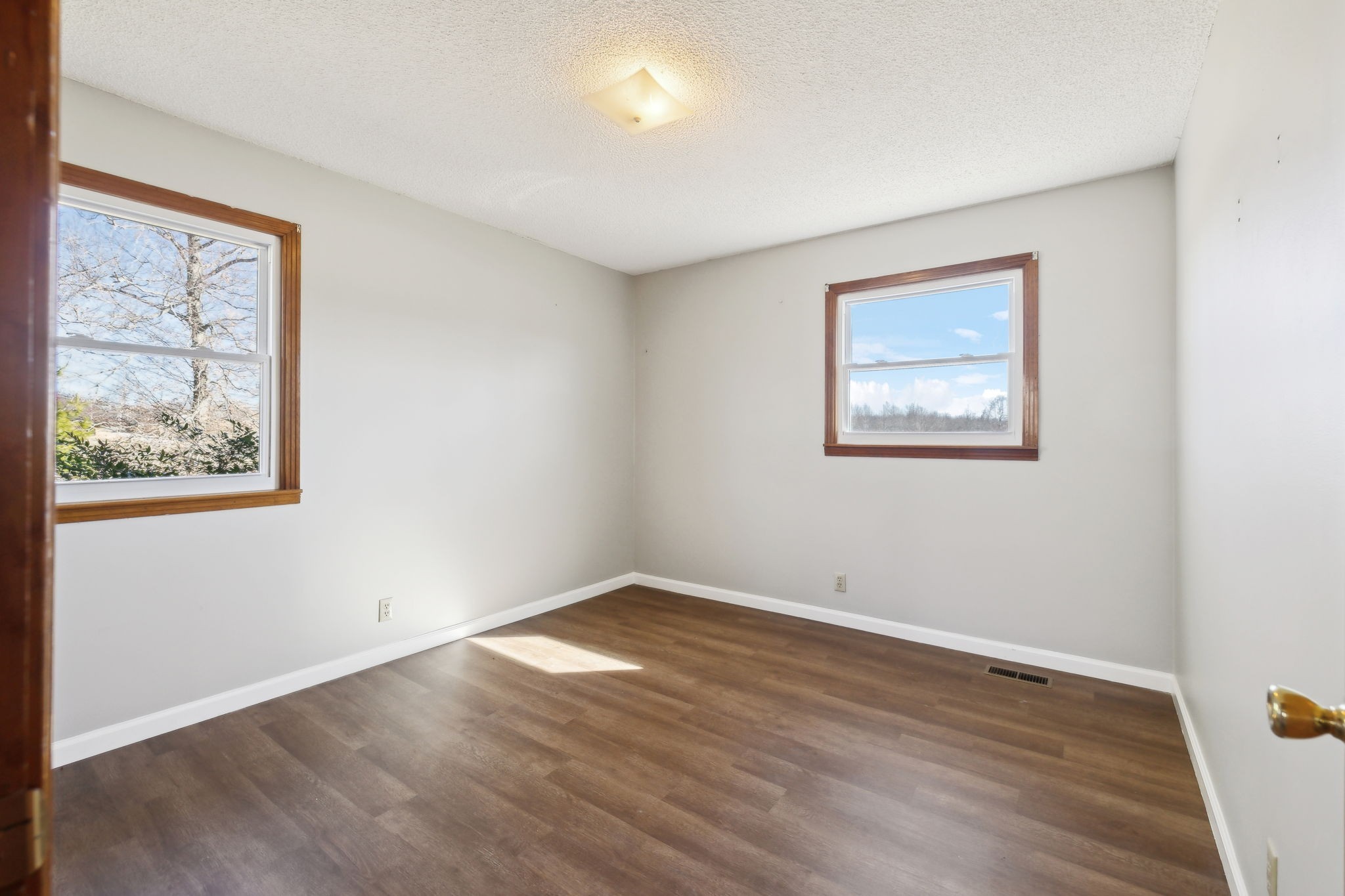 5880 Carthage Road Pleasant Shade, TN 37145 - Photo 25 of 45 a view of an empty room with wooden floor and a window