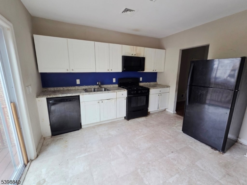 541 Fulton Street Elizabeth Port, NJ 07206 - Photo 2 of 14 a kitchen with a refrigerator sink and stove top oven