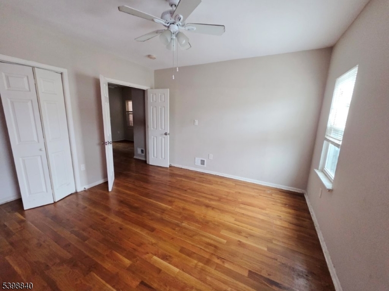 541 Fulton Street Elizabeth Port, NJ 07206 - Photo 4 of 14 a view of an empty room with wooden floor and a window