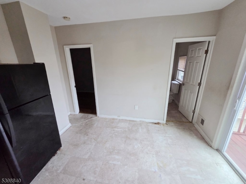 541 Fulton Street Elizabeth Port, NJ 07206 - Photo 5 of 14 an empty room with windows