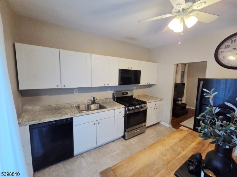 541 Fulton Street Elizabeth Port, NJ 07206 - Photo 10 of 14 a kitchen with a sink appliances and cabinets