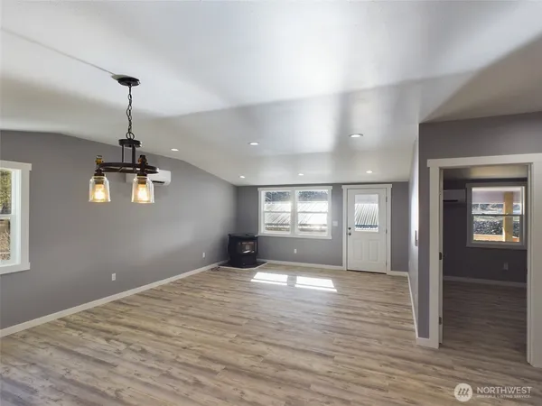 a view of empty room with wooden floor