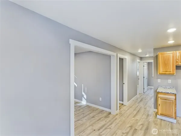 a view of a big room with wooden floor and bathroom