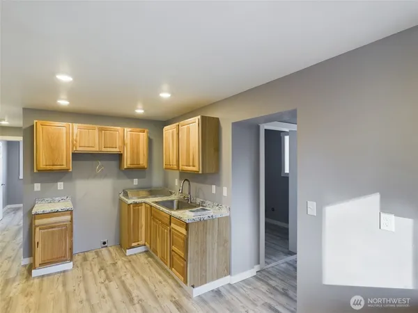 a kitchen with a sink stove and cabinets