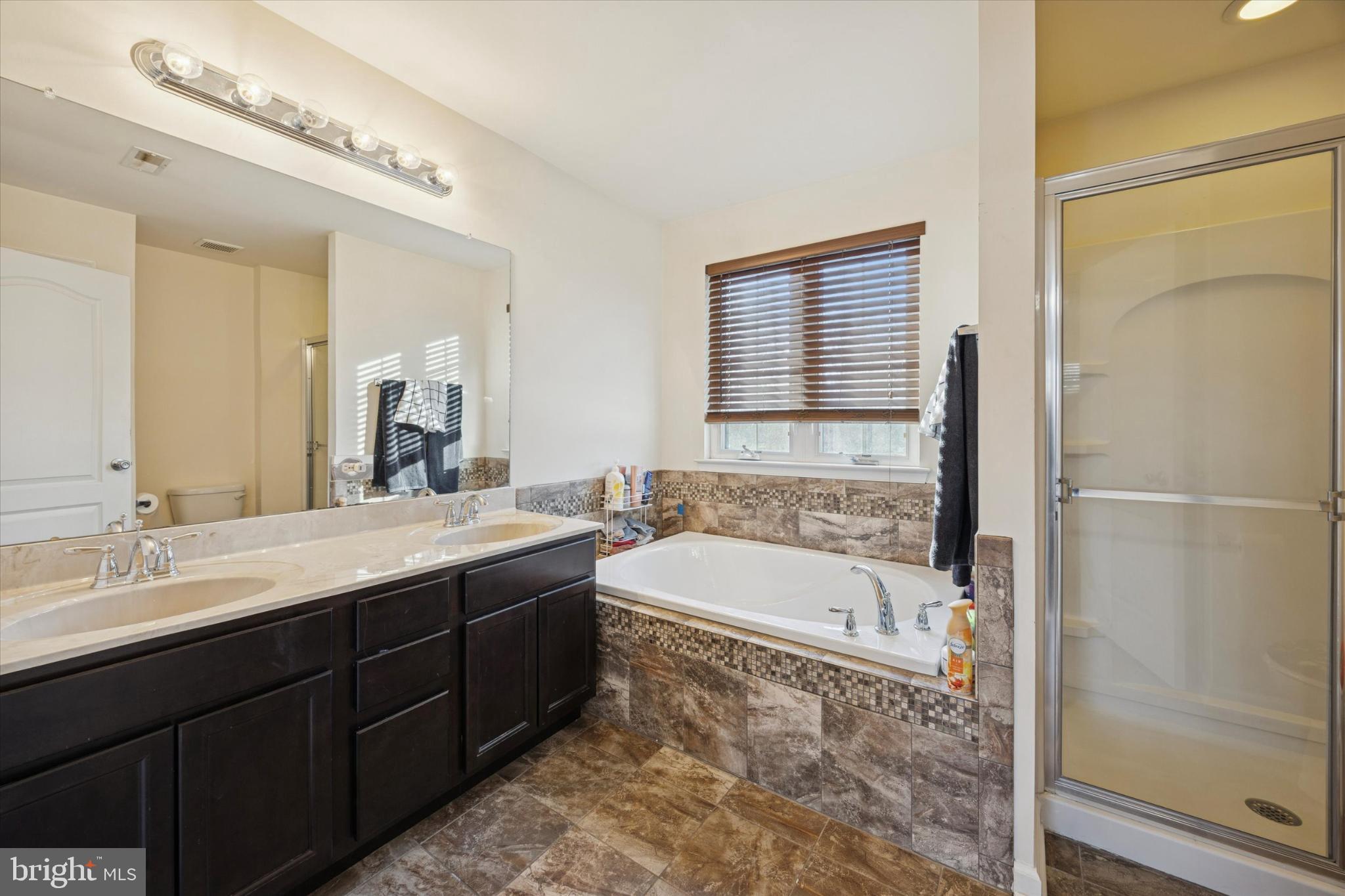 106 Nottingham Lane Newfield, NJ 08344 - Photo 20 of 29 a spacious bathroom with a tub sink and mirror