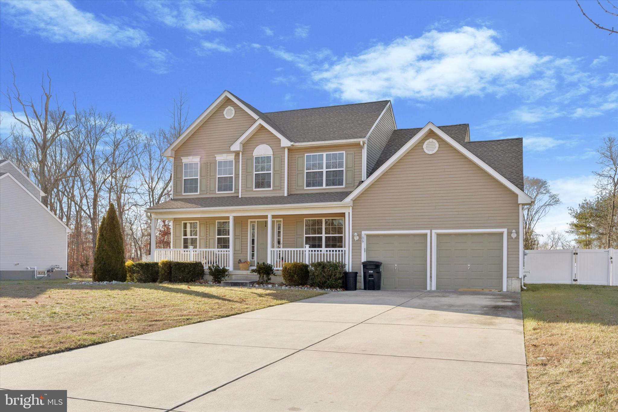 106 Nottingham Lane Newfield, NJ 08344 - Photo 2 of 29 a front view of a house with a yard and garage
