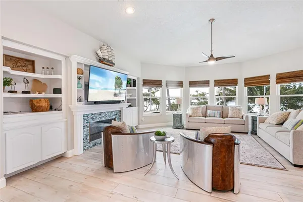 a dining room with stainless steel appliances granite countertop a table and chairs