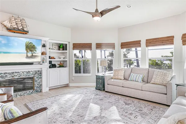 a kitchen with granite countertop a refrigerator and white cabinets