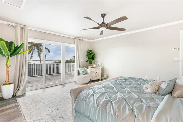 a bedroom with a bed and painting on the wall