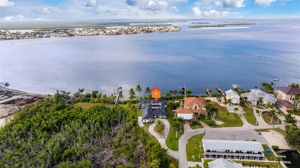 a backyard of a house with potted plants and water view