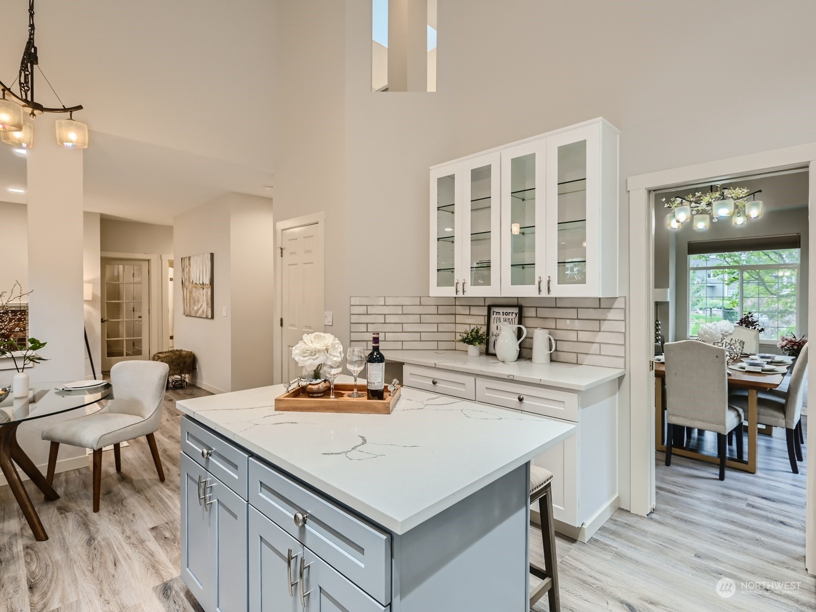 11216 39th Drive Southeast Everett, WA 98208 - Photo 13 of 40 a kitchen with a stove a sink dishwasher a dining table and chairs with wooden floor