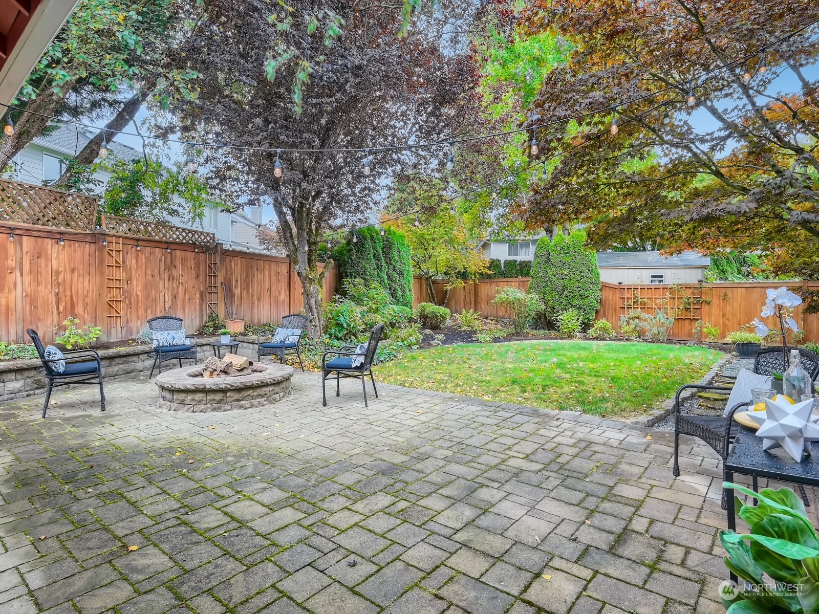 11216 39th Drive Southeast Everett, WA 98208 - Photo 33 of 40 a view of a backyard with table and chairs potted plants and tree