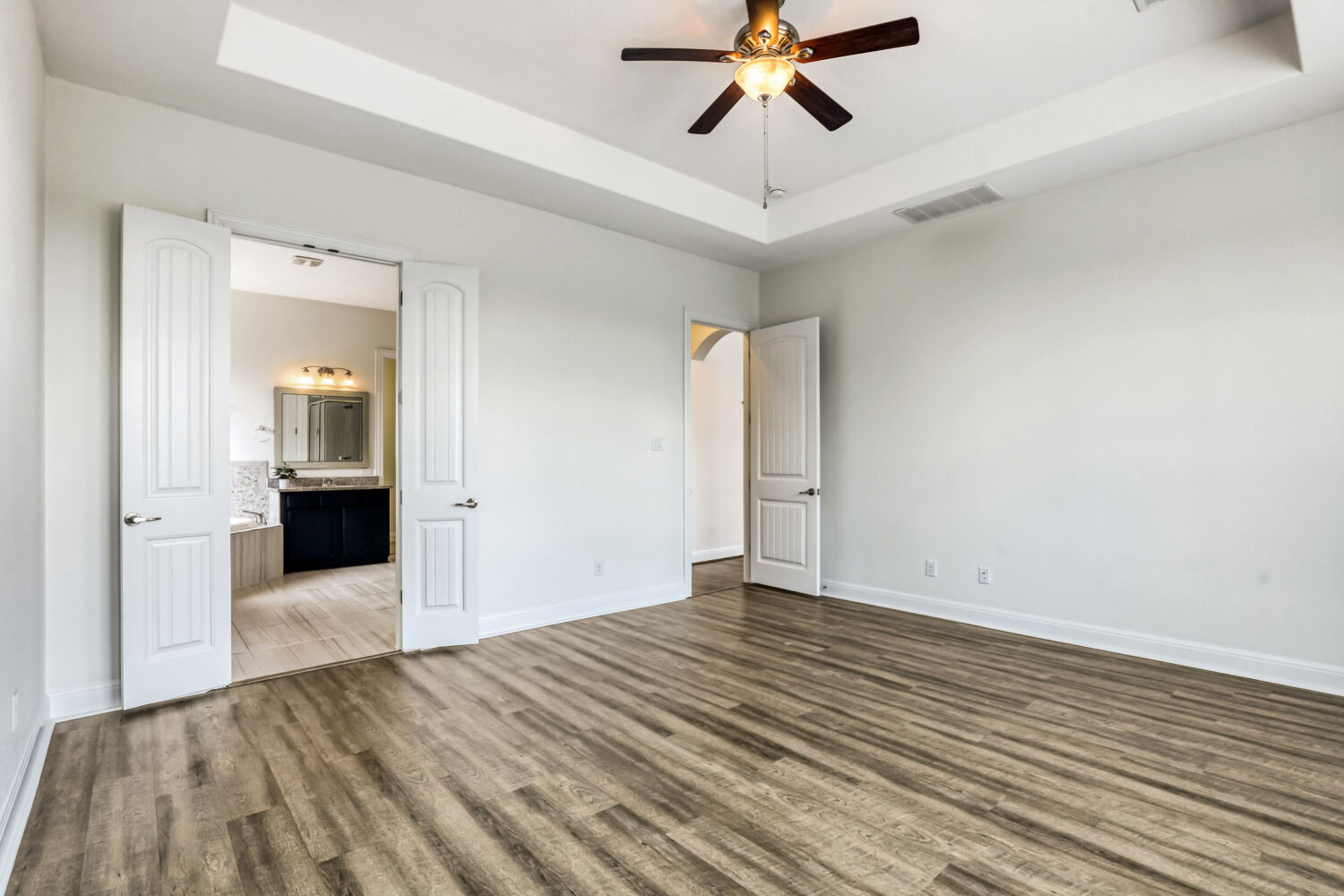 19205 Burrowbridge Road Pflugerville, TX 78660 - Photo 16 of 38 Spacious primary suite features tray ceiling, giant bay window with greenbelt views
