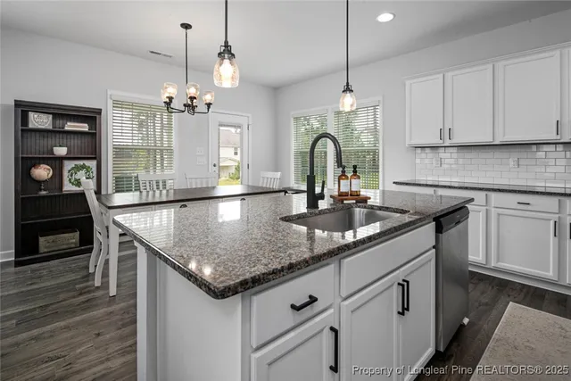 a kitchen with sink cabinets and wooden floor