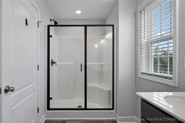 a bathroom with a glass shower door