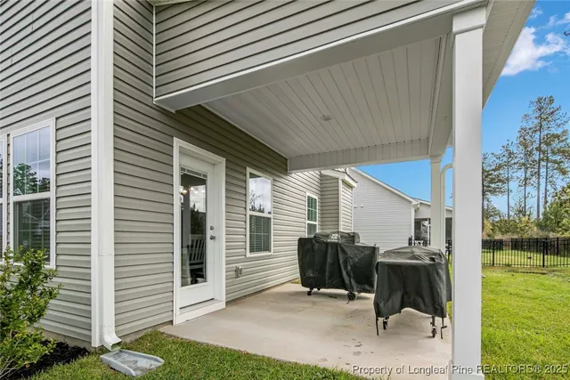 a view of a backyard with furniture and garden