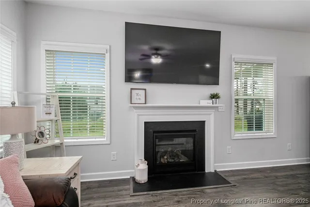 a living room with a fireplace a flat screen tv and a fireplace