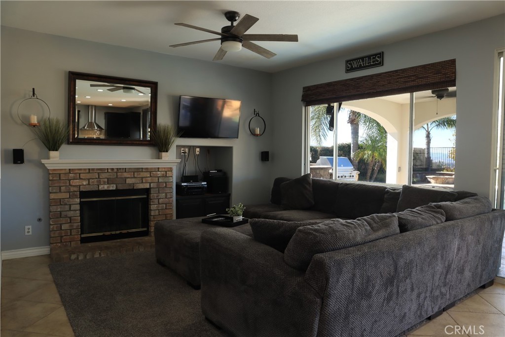 28469 Via Joyce Drive Saugus, CA 91350 - Photo 16 of 23 a living room with furniture a flat screen tv and a fireplace