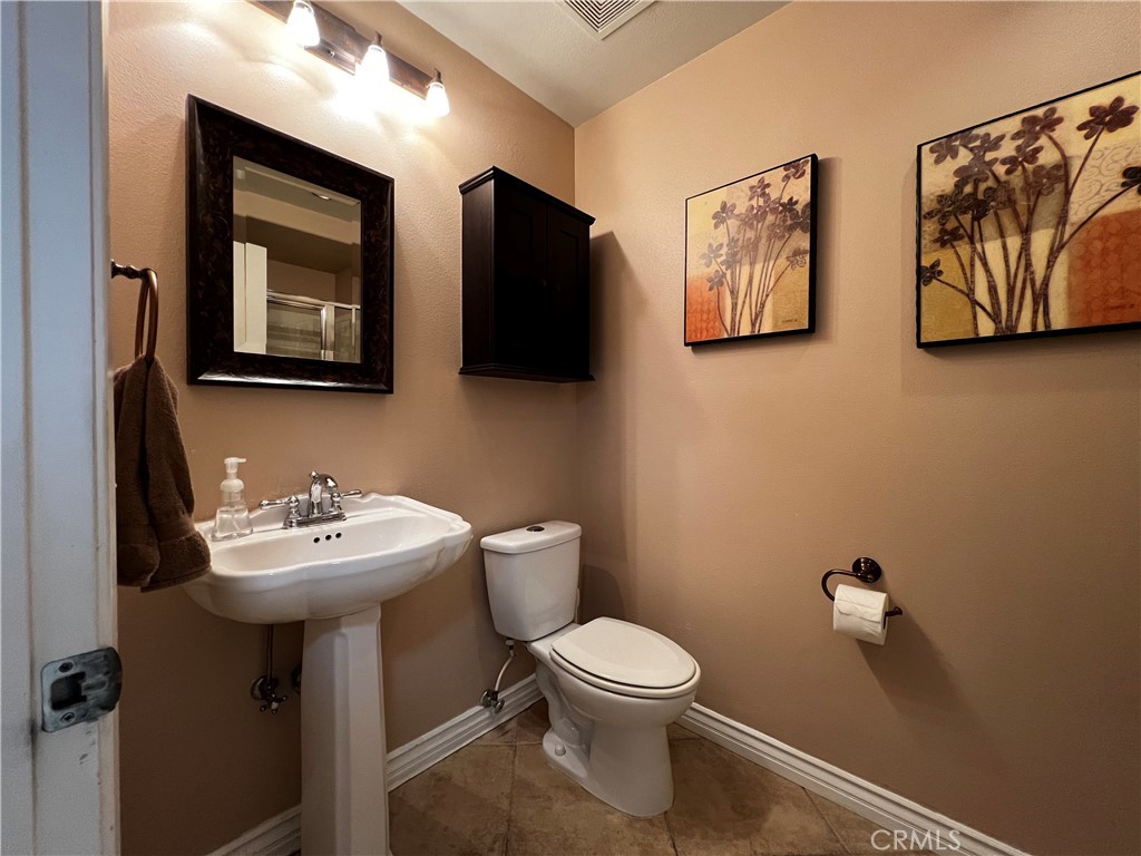 28469 Via Joyce Drive Saugus, CA 91350 - Photo 18 of 23 a bathroom with a toilet sink and mirror