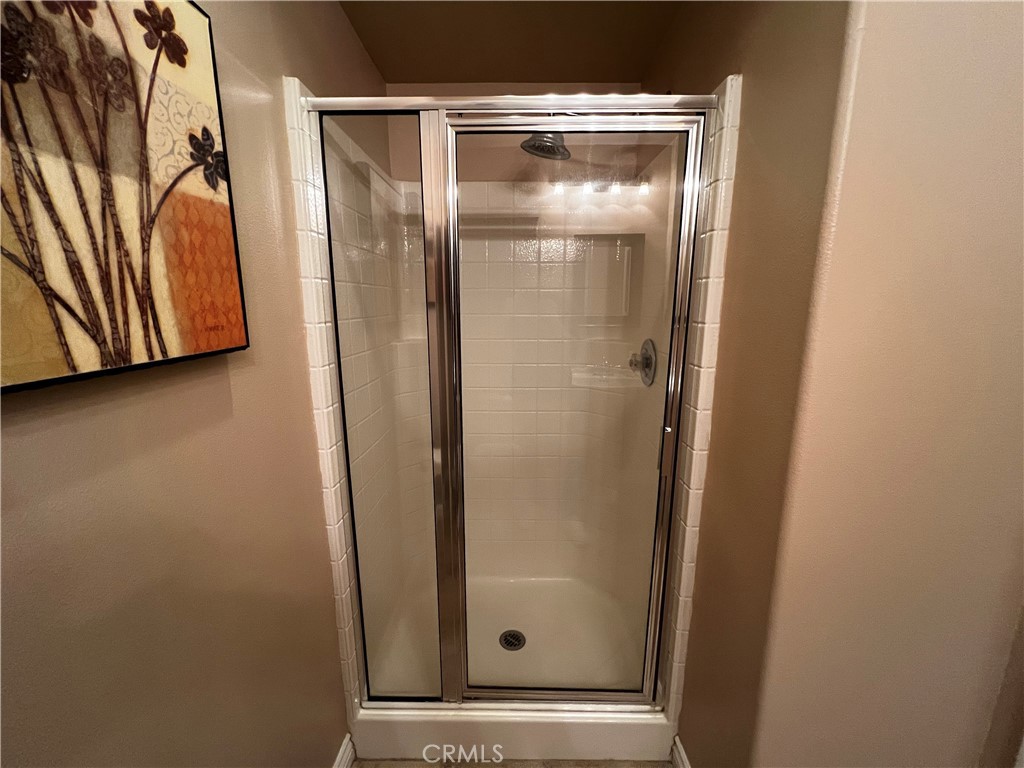 28469 Via Joyce Drive Saugus, CA 91350 - Photo 19 of 23 a bathroom with a glass door shower