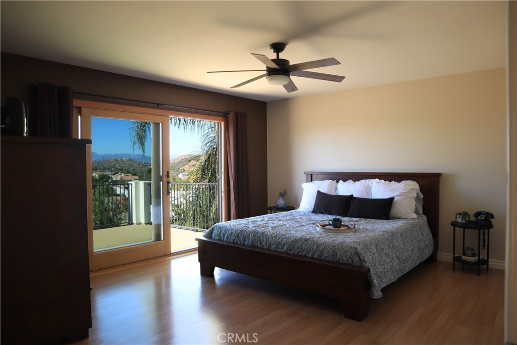 28469 Via Joyce Drive Saugus, CA 91350 - Photo 21 of 23 a bedroom with a large bed and a large window