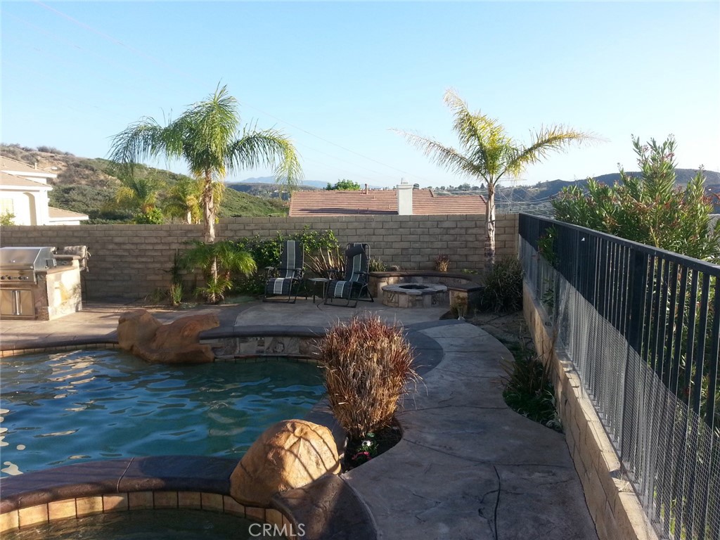 28469 Via Joyce Drive Saugus, CA 91350 - Photo 10 of 23 a view of a patio with table and chairs potted plants with wooden floor