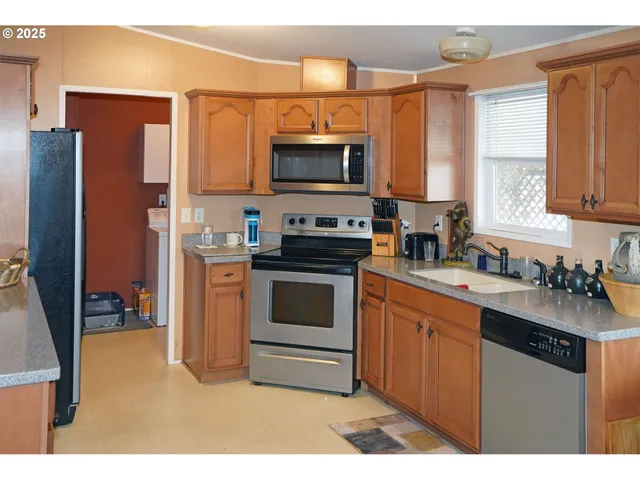 a kitchen with a sink stove and refrigerator
