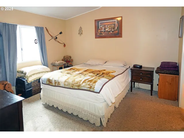 a bed sitting in a bedroom next to a window