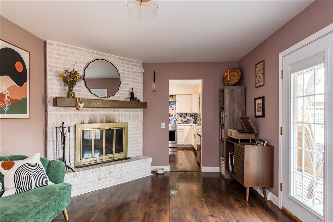 4102 Ridgetop Drive Bellbrook, OH 45305 - Photo 13 of 33 This inviting space features a charming fireplace, rich hardwood floors, and seamless kitchen access.