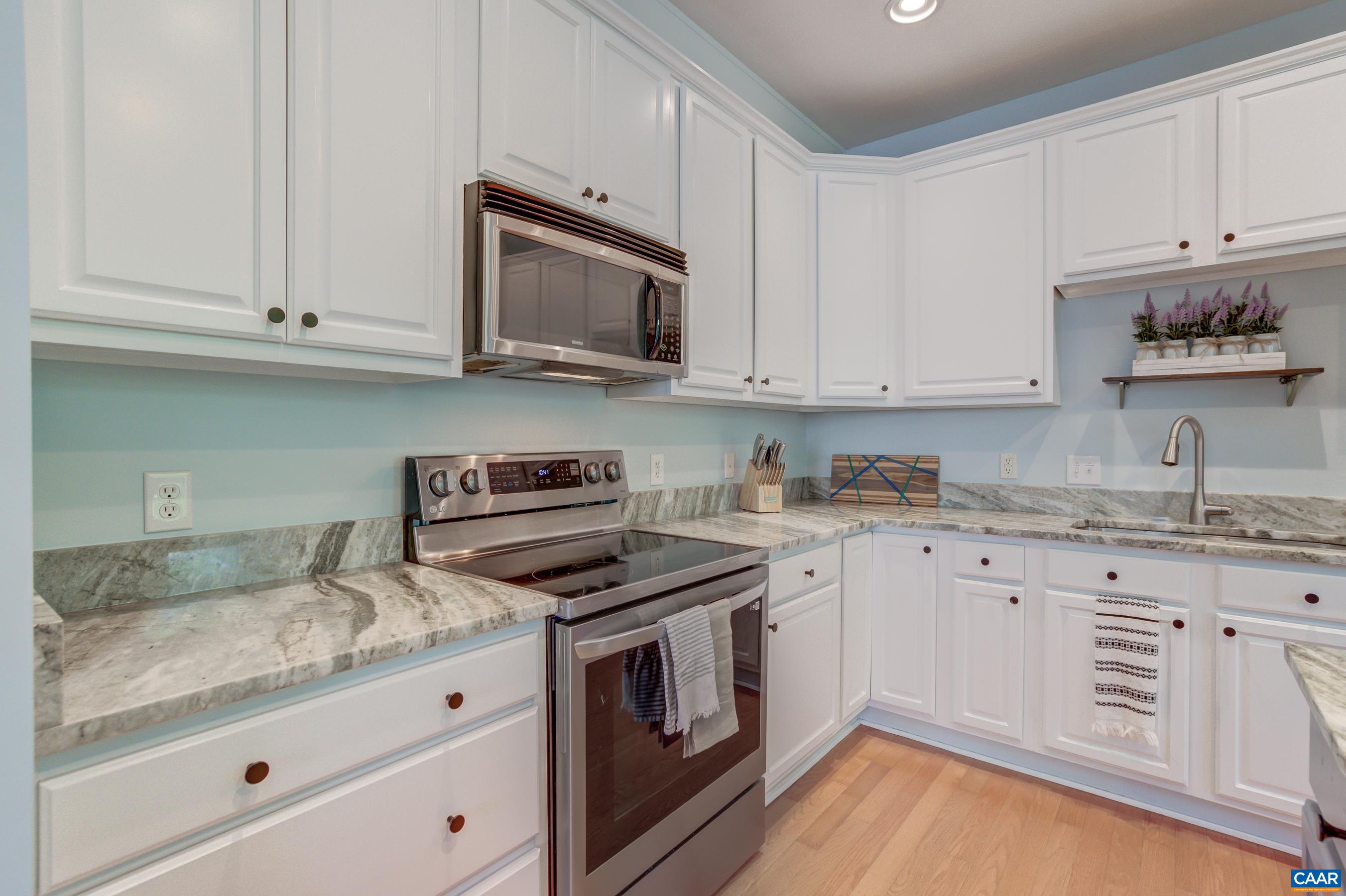 5448 Park Road Crozet, VA 22932 - Photo 16 of 28 a kitchen with granite countertop white cabinets and stainless steel appliances