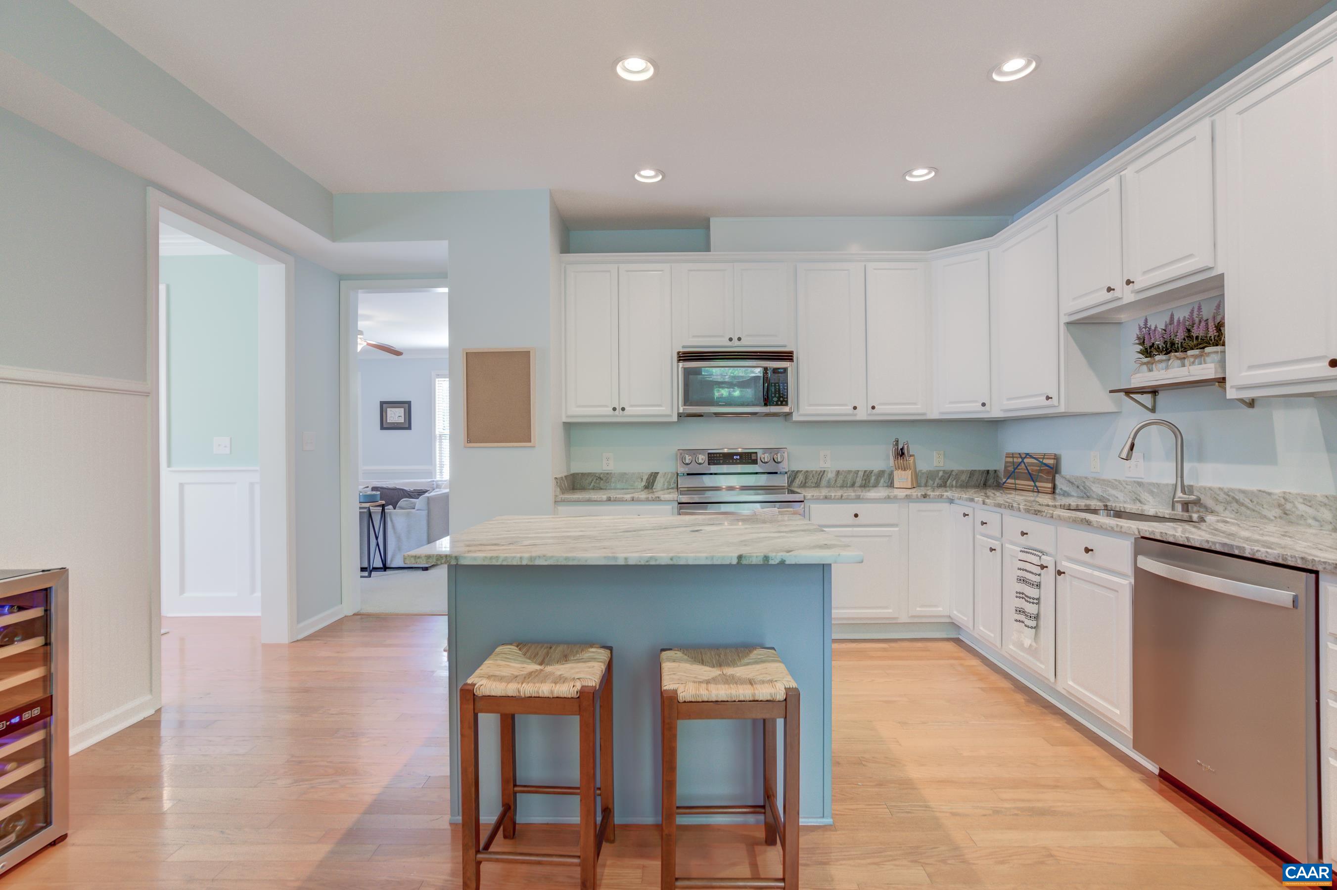 5448 Park Road Crozet, VA 22932 - Photo 20 of 28 a kitchen with kitchen island granite countertop wooden cabinets and refrigerator