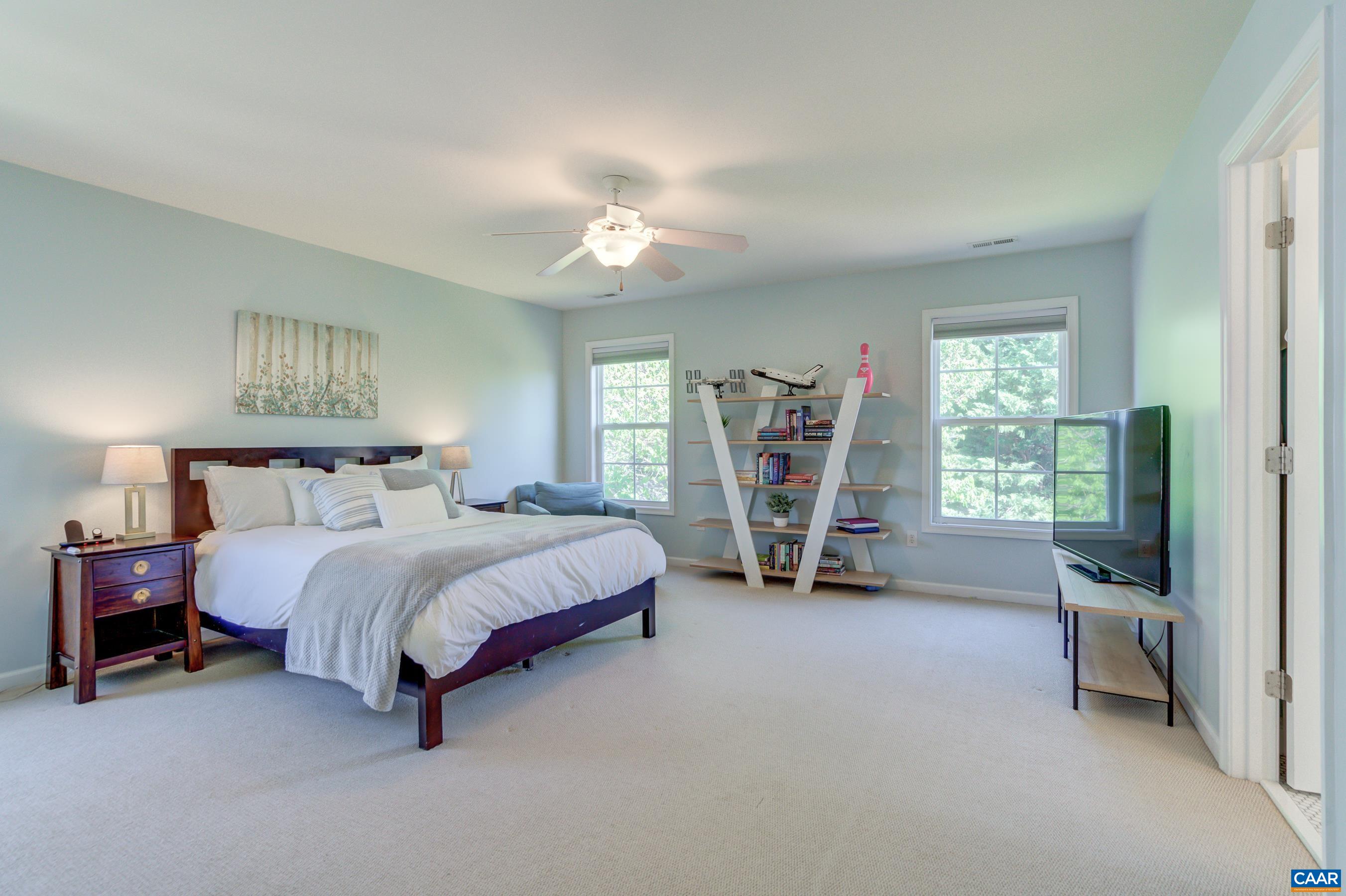 5448 Park Road Crozet, VA 22932 - Photo 21 of 28 a spacious bedroom with a bed and a large window