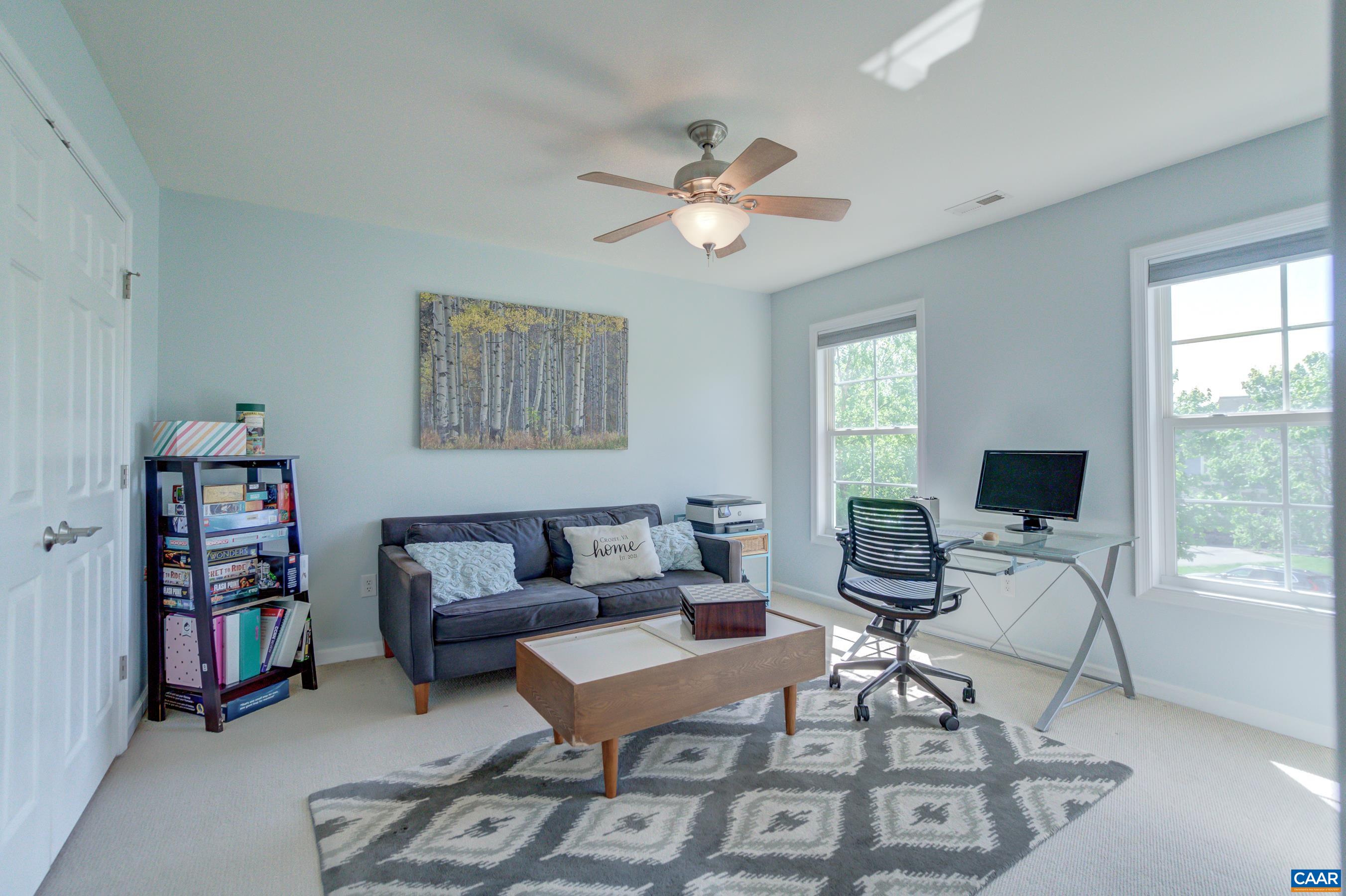 5448 Park Road Crozet, VA 22932 - Photo 27 of 28 a living room with furniture a bookshelf and a window
