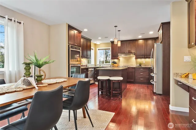 a view of a dining room with furniture window and wooden floor