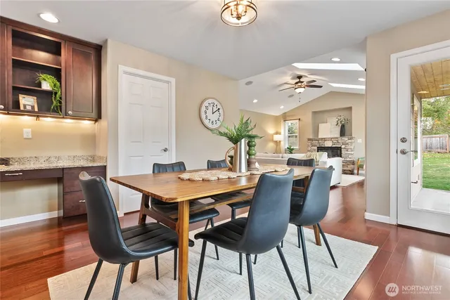 a view of a dining room with furniture and wooden floor