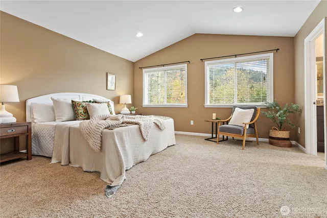 a bedroom with bed and a large window