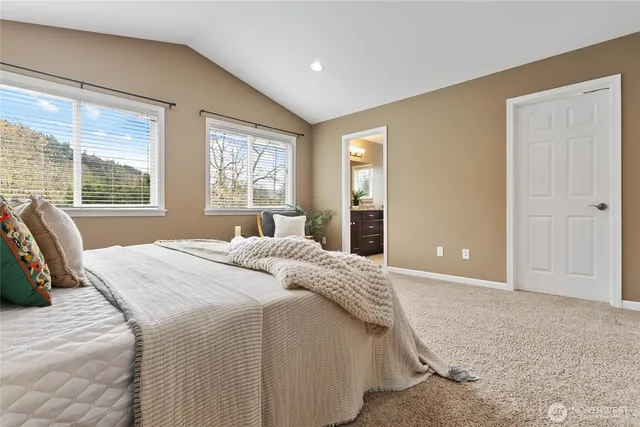 a bedroom with a large bed and a large window