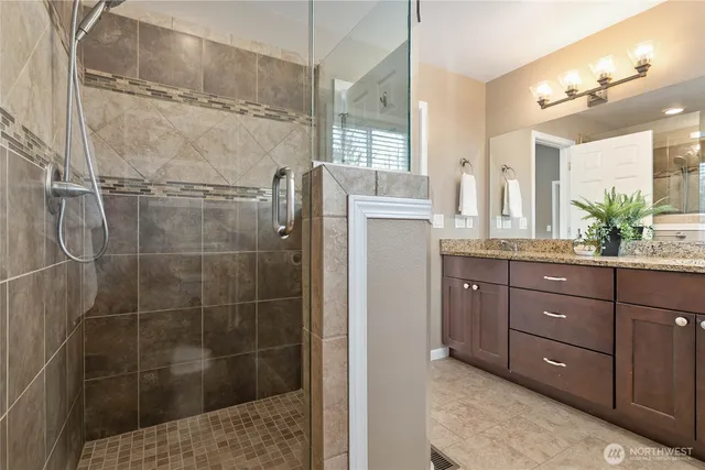 a bathroom with a shower sink and mirror