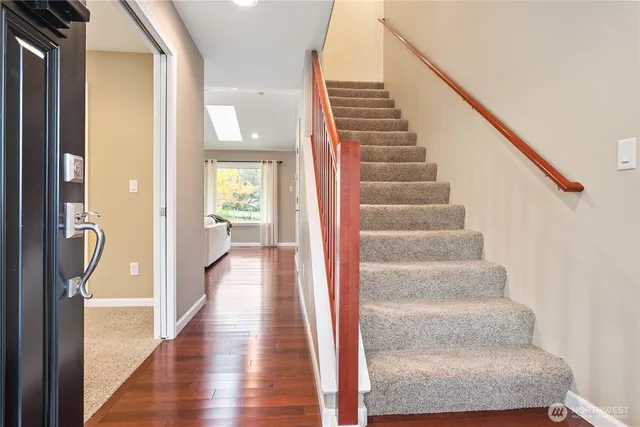 a view of a hallway with wooden floor and entryway