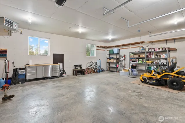 a view of a garage with furniture and cars