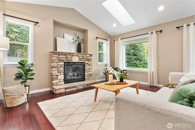 a living room with a couch a large window and a fireplace